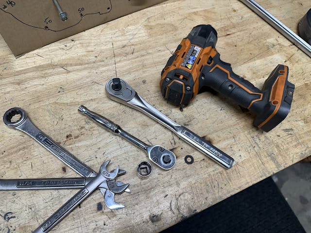 ratchet, socket, and wrenches, big ratchet on workbench with impact
