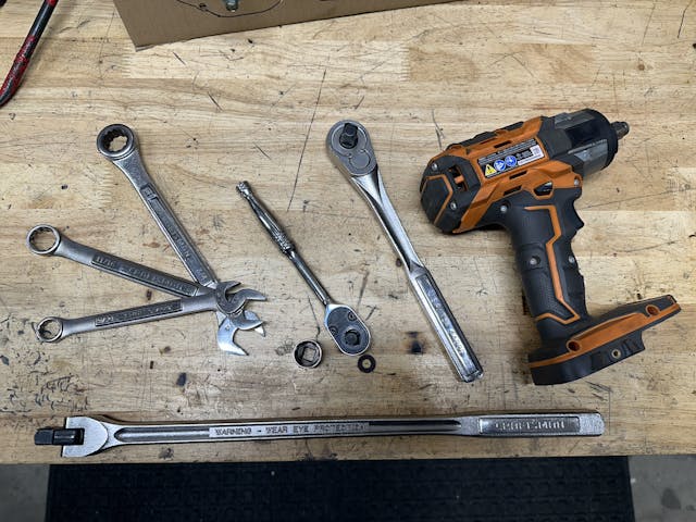 wrenches, sockets, impact and breaker bar on workbench