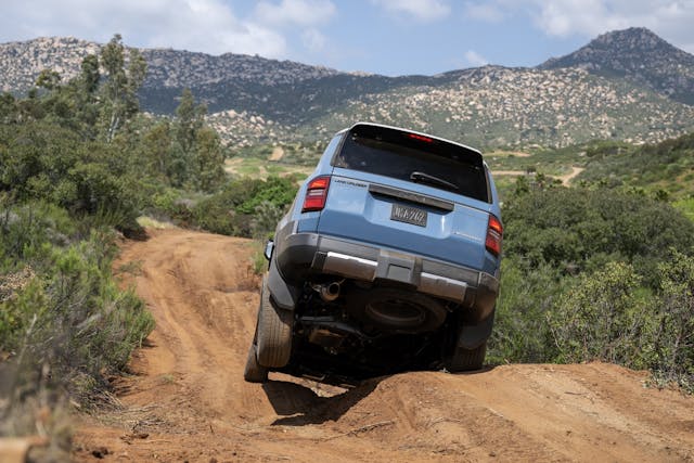 2024 Toyota Land Cruiser Heritage Blue off road course action rear