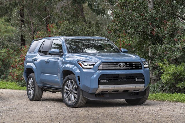 2025 Toyota 4Runner Limited exterior Heritage Blue front three quarter against fruit trees