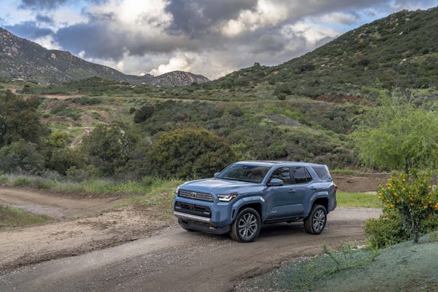 2025 Toyota 4Runner Limited exterior Heritage Blue high front three quarter in mountains