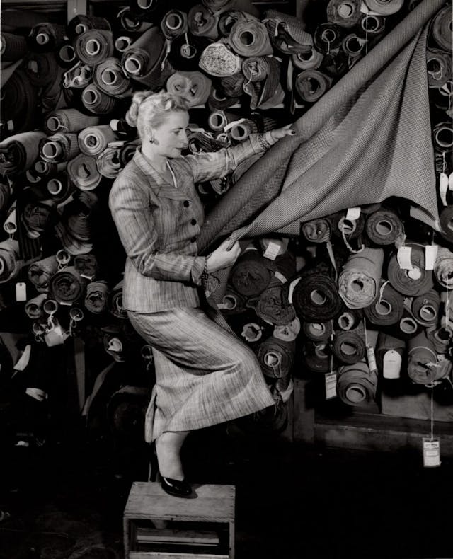 Helen Rother examining textiles Nash 1953