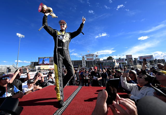 Bob Tasca III celebrates after winning the NHRA 4-Wide Nationals at The Strip trophy