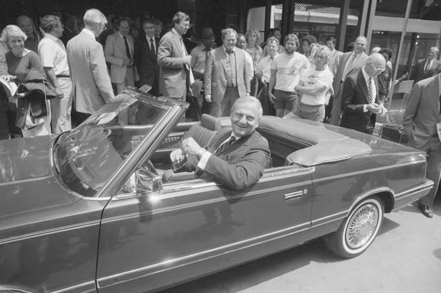 Lee Iacocca Siting in Chrysler Convertible