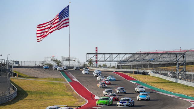 Porsche Endurance Challenge North America COTA 911 Cup cars on track big American flag