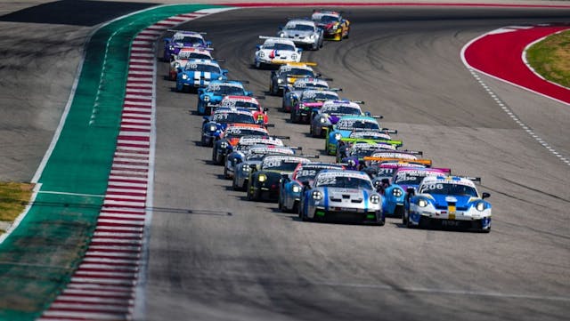 Porsche Endurance Challenge North America 911 Cup cars in two columns heading on to front straight at COTA