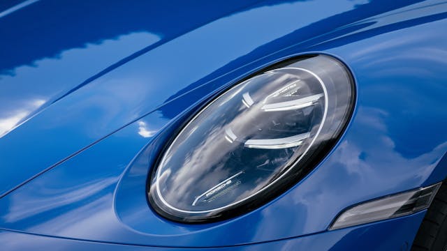 2025 Porsche 911 Carrera Coupe exterior headlight detail blue body