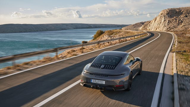 2025 Porsche 911 Carrera GTS Coupe exterior grey rear three quarter driving on road