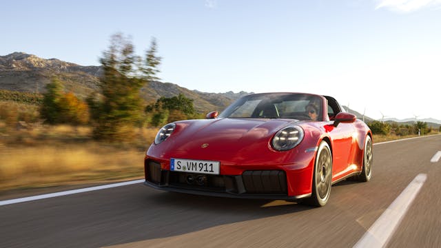 2025 Porsche 911 Targa 4 GTS exterior red low front three quarter driving on road at golden hour
