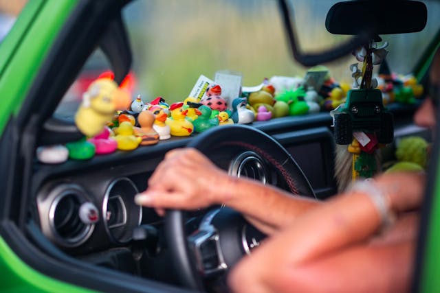 Duck Duck Jeep Toledo Jeepfest dashboard covered in ducks with hand on steering wheel