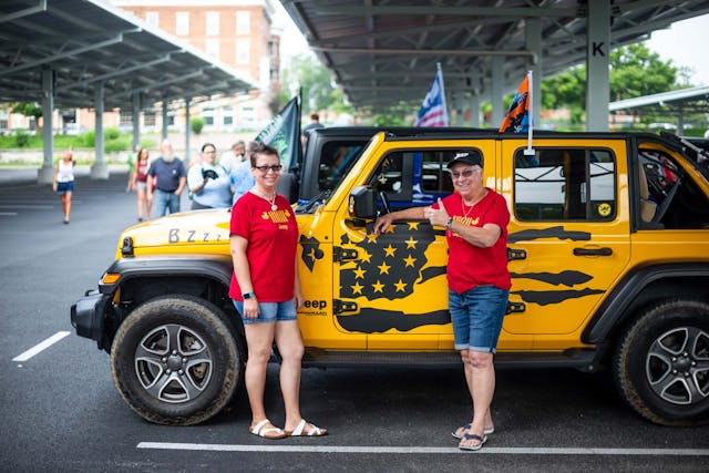 Duck Duck Jeep Toledo Jeepfest twp ladies in front of yellow Wrangler in parking lot
