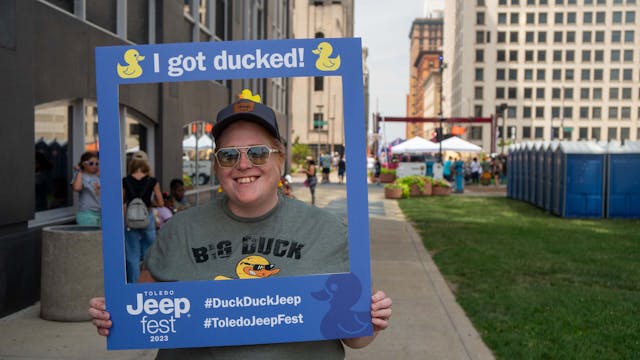 Duck Duck Jeep Toledo Jeepfest Allison smiling with portable duck sign