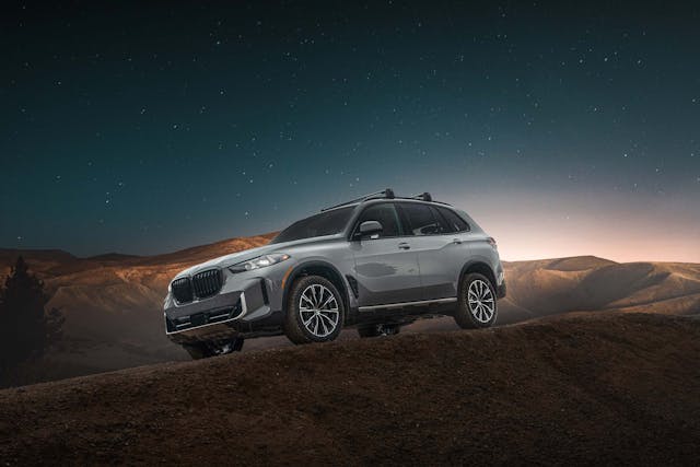 2025 BMW X5 Silver Anniversary Edition exterior front three quarter angled under starry sky