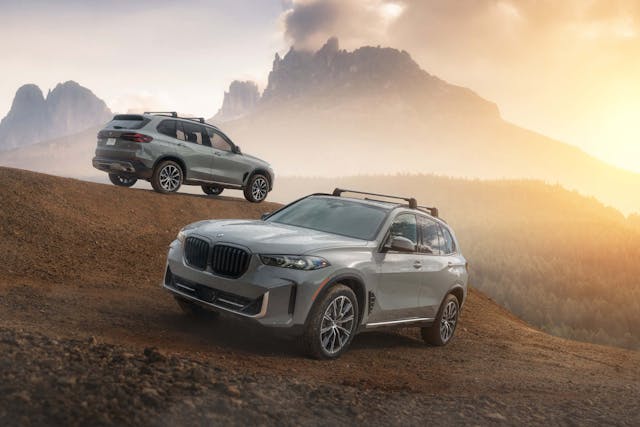 2025 BMW X5 Silver Anniversary Edition exterior two car front three quarter and rear three quarter