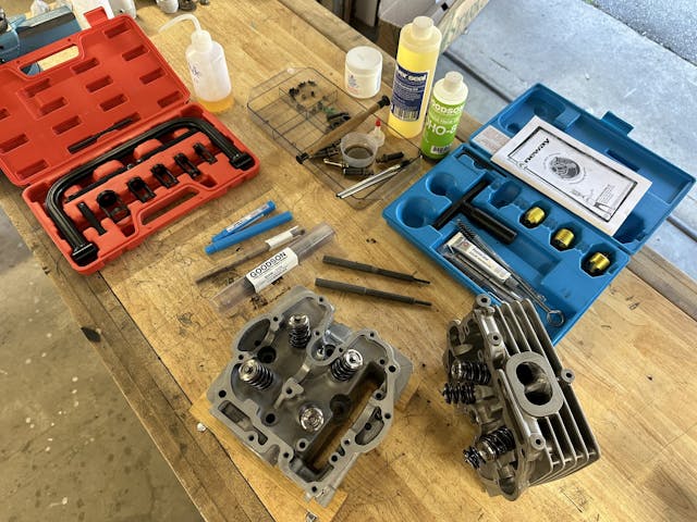 Honda XR250r heads and tools on workbench