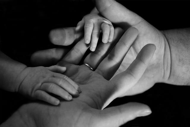 family first hands together over black