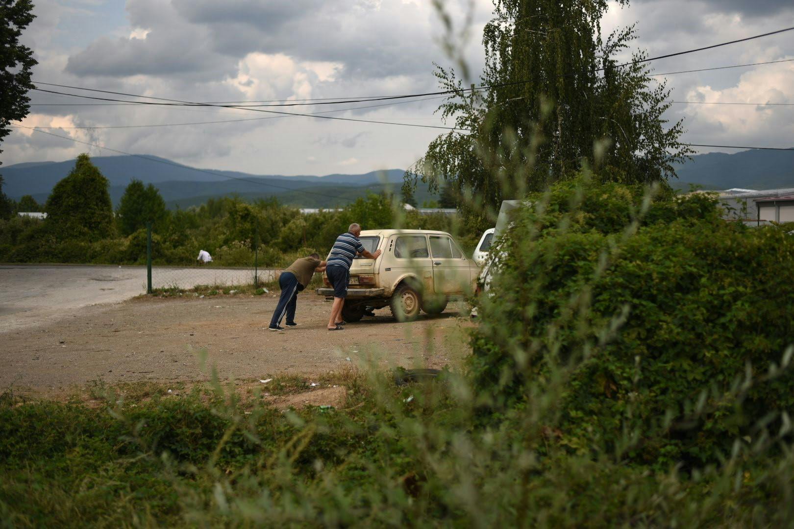 Lada Niva Eastern European men pushing