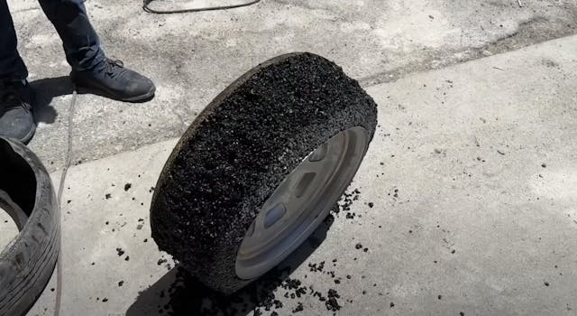 Stone wheels on a car experiment asphalt tire overhead