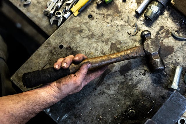 Workshop man hands hammer