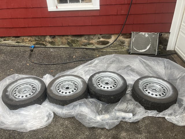 steel wheels with tires on ground lined up