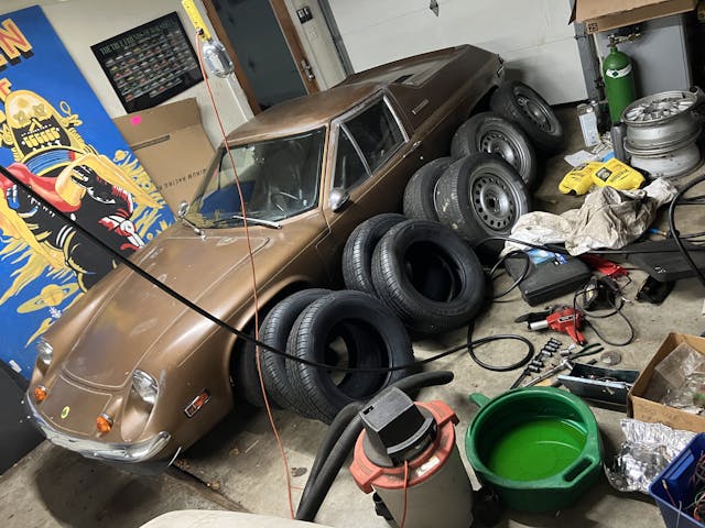 old tires leaning against lotus europa