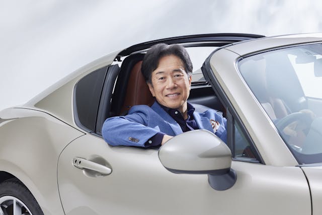 Masahiro Moro, Mazda CEO sitting inside of Miata RF