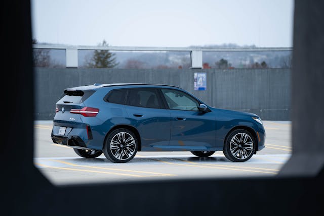 2025 BMW X3 30 xDrive exterior rear three quarter through garage
